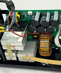 Open electronic power supply enclosure showing capacitors, transformer, heatsinks and wiring used for power regulation inside a metal chassis.
